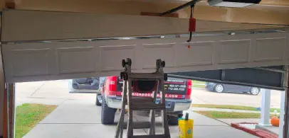 Garage door repair technician servicing a door in Omaha