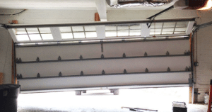 Garage door rollers keep slipping off the track